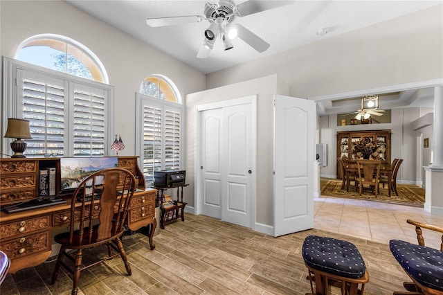 home office with light wood-type flooring and ceiling fan