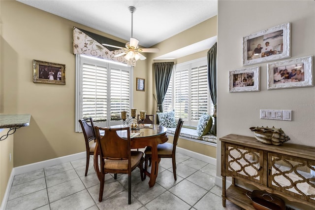 dining space featuring ceiling fan and light tile patterned flooring