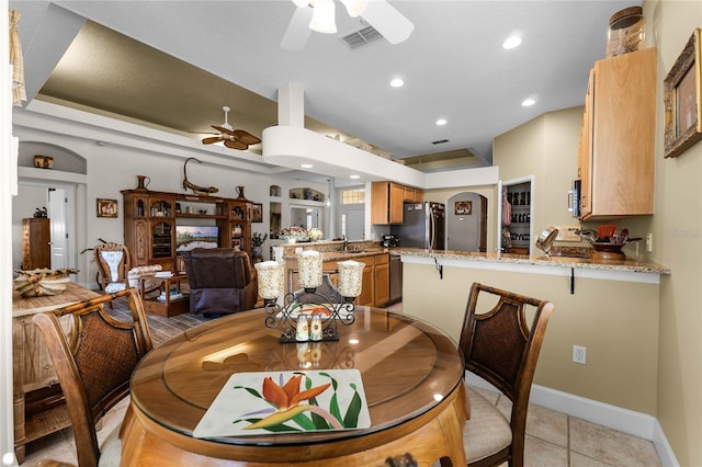 dining space with light tile patterned flooring and ceiling fan