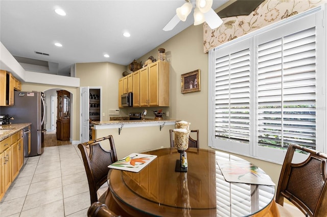 tiled dining area featuring ceiling fan