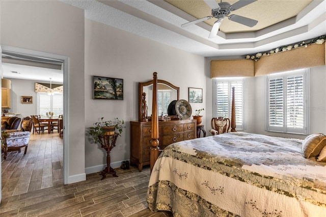 bedroom featuring ceiling fan and a tray ceiling