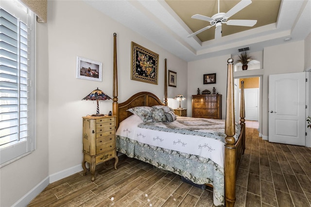 bedroom featuring a tray ceiling and ceiling fan