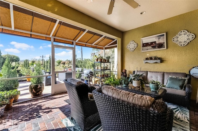 sunroom / solarium featuring ceiling fan