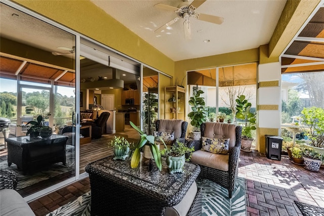 sunroom featuring vaulted ceiling and ceiling fan