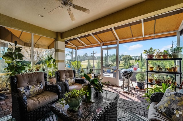 sunroom featuring ceiling fan