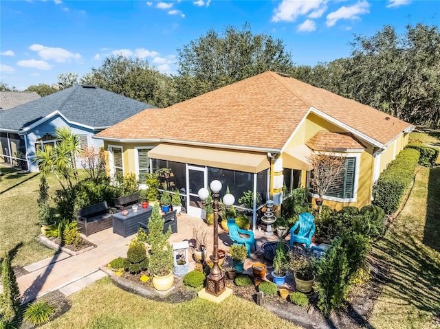 rear view of property with a patio and an outdoor living space with a fire pit