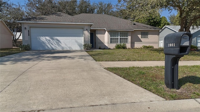 single story home featuring a garage and a front yard