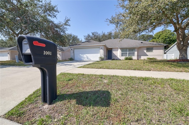 view of front of house with a garage and a front lawn