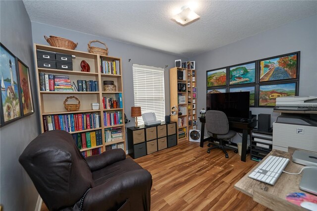 office area featuring wood-type flooring and a textured ceiling