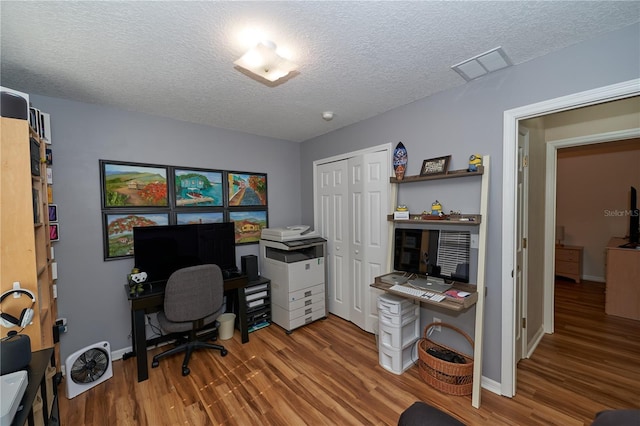 office featuring hardwood / wood-style flooring and a textured ceiling