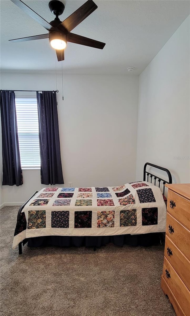 bedroom featuring dark colored carpet and ceiling fan