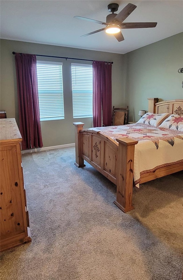 bedroom featuring ceiling fan and carpet