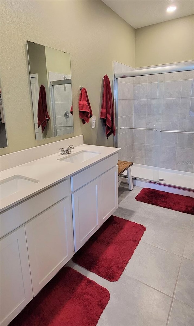 bathroom featuring vanity and an enclosed shower