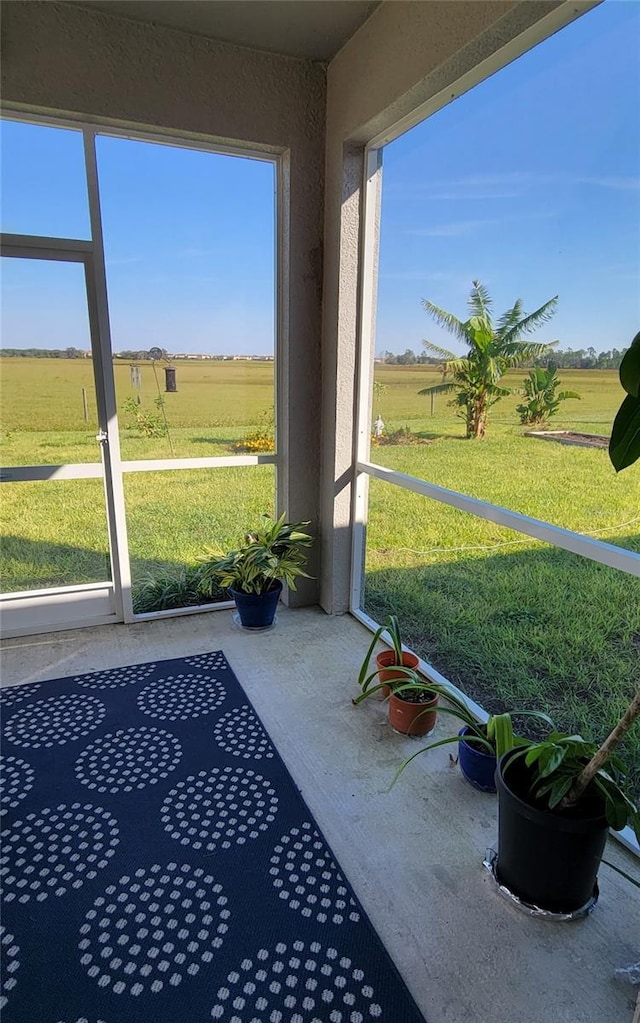 sunroom / solarium with a wealth of natural light and a rural view