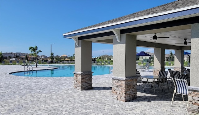 view of pool with a patio and ceiling fan