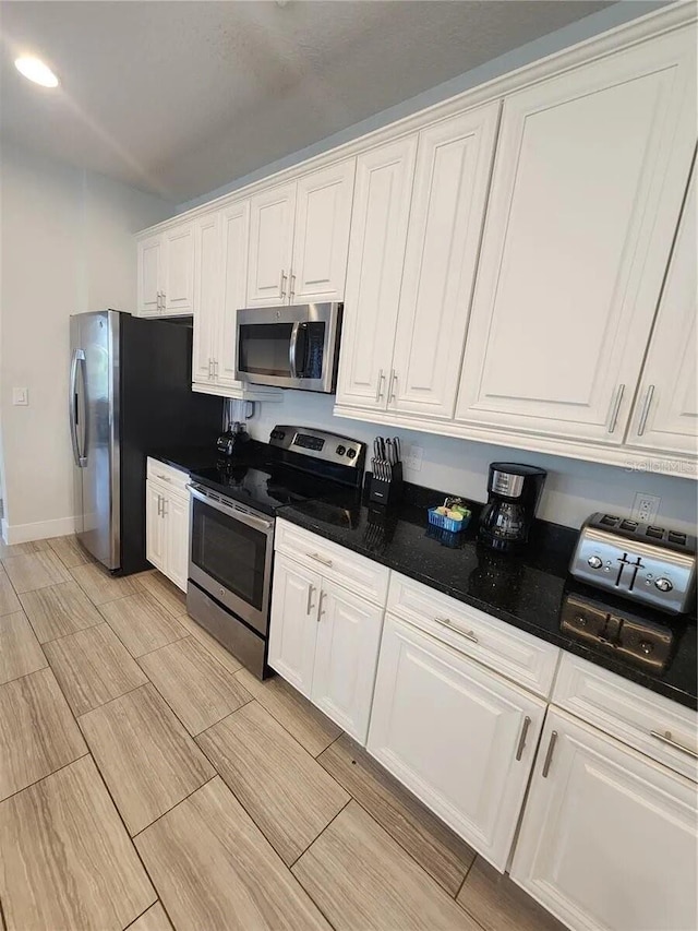 kitchen with stainless steel appliances and white cabinetry