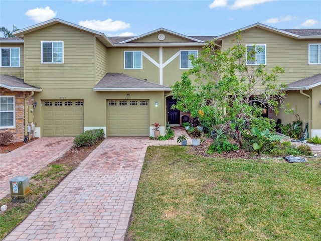 view of front of house with a garage and a front lawn