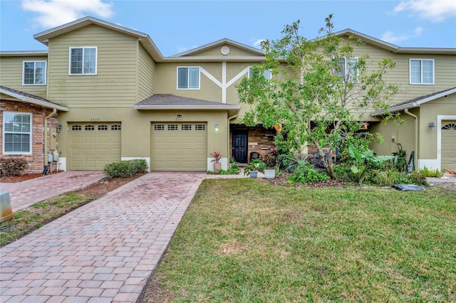 view of front of property featuring a garage and a front yard