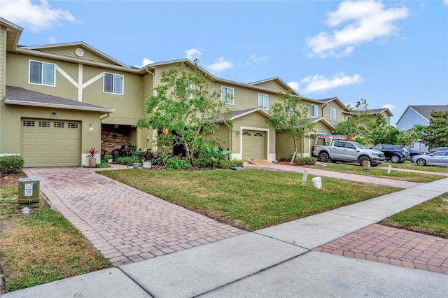 multi unit property with a garage and a front yard