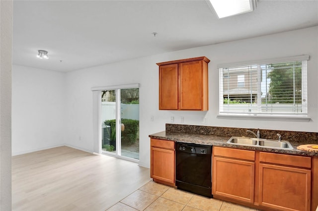 kitchen featuring plenty of natural light, black dishwasher, and sink