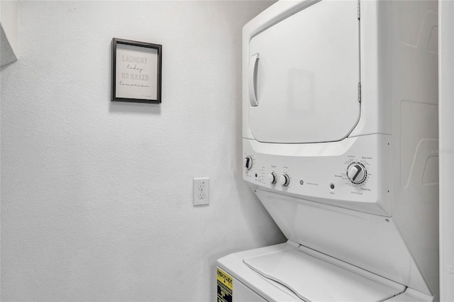 laundry room with stacked washer and dryer