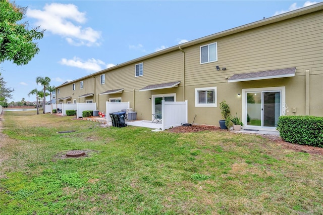 back of property featuring a yard and a patio area