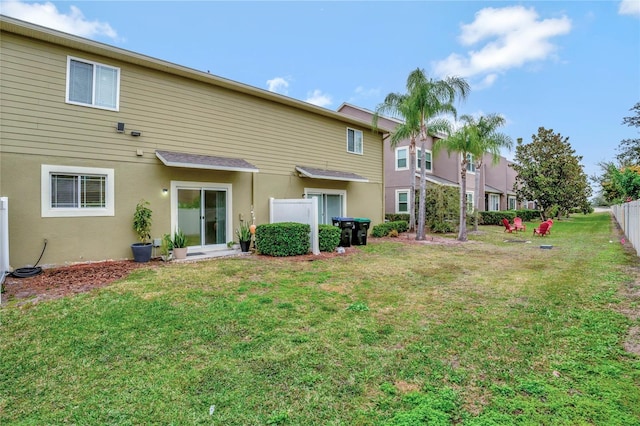 rear view of property with a lawn