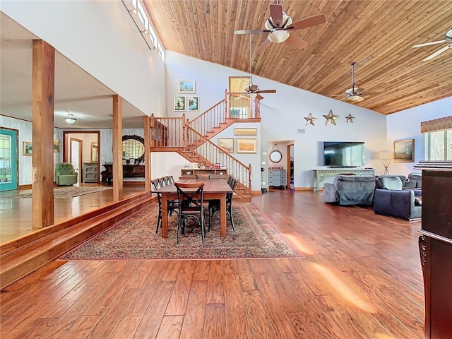 dining room featuring ceiling fan, hardwood / wood-style floors, wood ceiling, and high vaulted ceiling