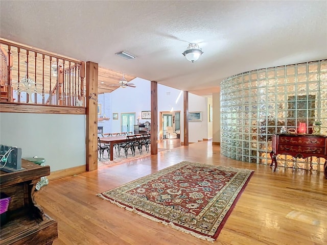 living room with ceiling fan, hardwood / wood-style floors, and a textured ceiling