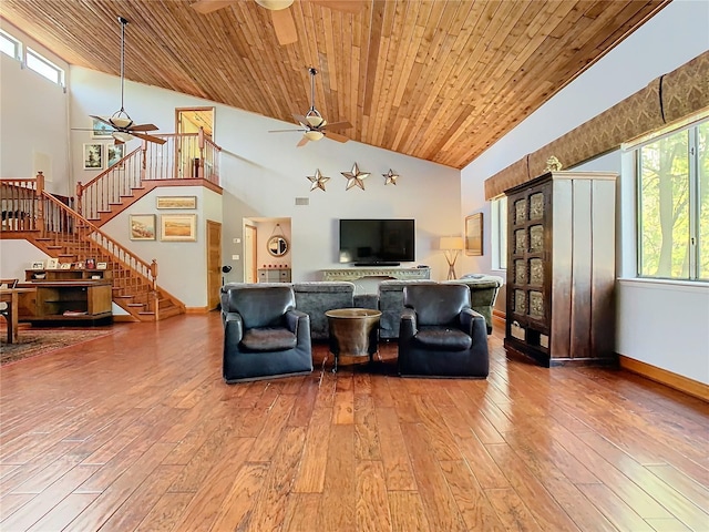 living room with hardwood / wood-style flooring, ceiling fan, wood ceiling, and high vaulted ceiling