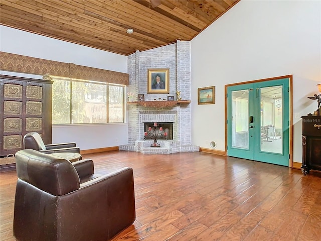 living room with wood ceiling, wood-type flooring, a fireplace, and high vaulted ceiling