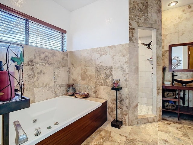 bathroom with independent shower and bath and tile walls