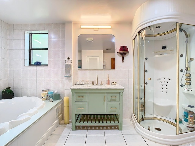 bathroom with tile patterned floors, independent shower and bath, tile walls, and vanity