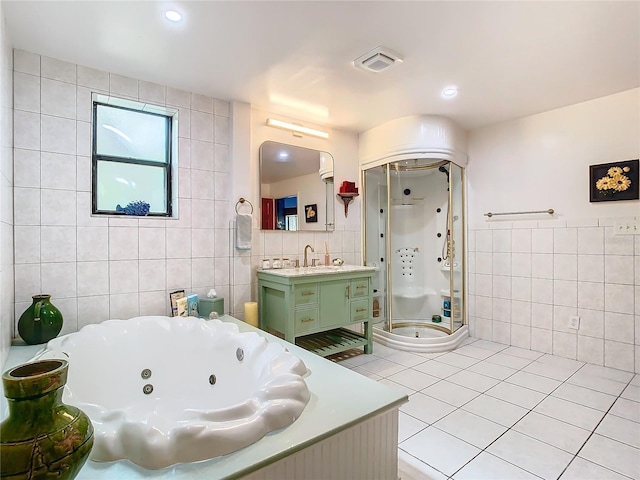 bathroom featuring tile walls, vanity, tile patterned flooring, and shower with separate bathtub