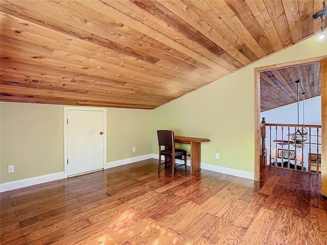 additional living space with hardwood / wood-style flooring, wood ceiling, and vaulted ceiling