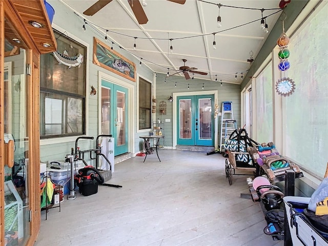 sunroom featuring ceiling fan and french doors