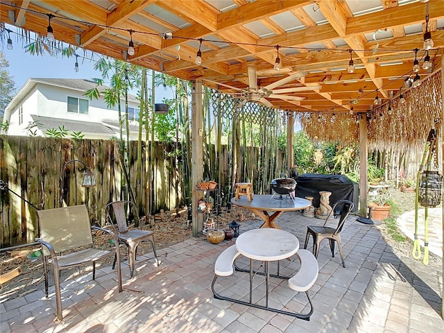 view of patio with area for grilling and ceiling fan