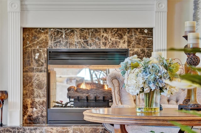 interior details featuring a tile fireplace