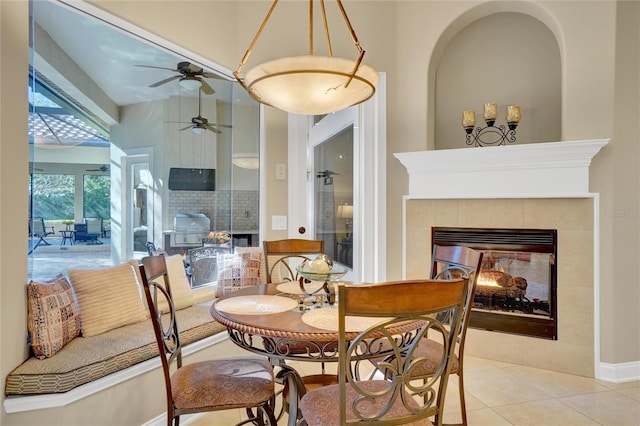 dining room featuring light tile patterned floors and a tile fireplace