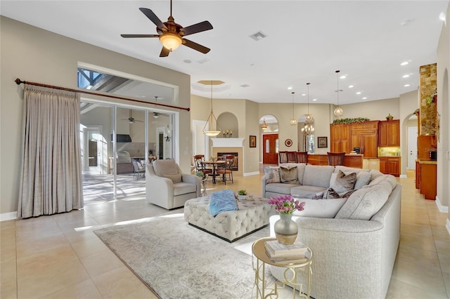 tiled living room with a towering ceiling and ceiling fan