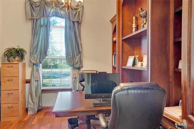 office area with a wealth of natural light and light hardwood / wood-style floors