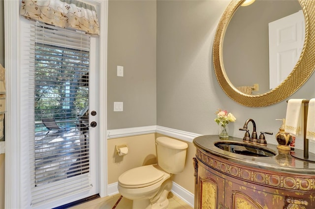 bathroom with vanity, tile patterned floors, and toilet