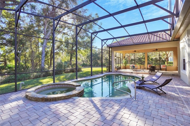 view of swimming pool with an in ground hot tub, glass enclosure, ceiling fan, and a patio area