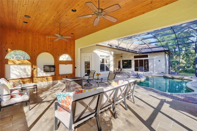 view of swimming pool featuring a patio, a lanai, an outdoor hangout area, and ceiling fan