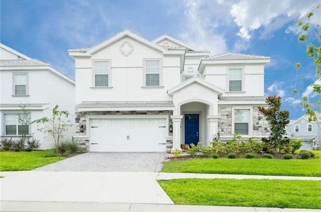 view of front facade with a garage and a front lawn