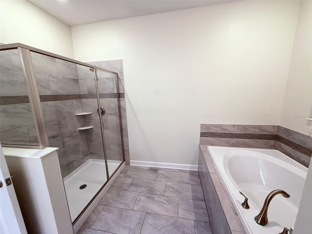 bathroom with plus walk in shower and tile patterned flooring