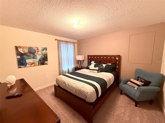 bedroom with carpet and a textured ceiling