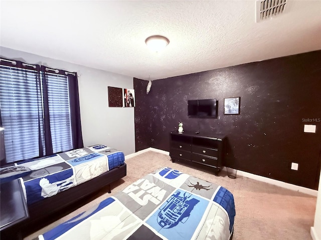 carpeted bedroom featuring a textured ceiling