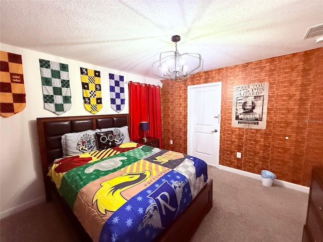 bedroom with brick wall, a chandelier, carpet floors, and a textured ceiling