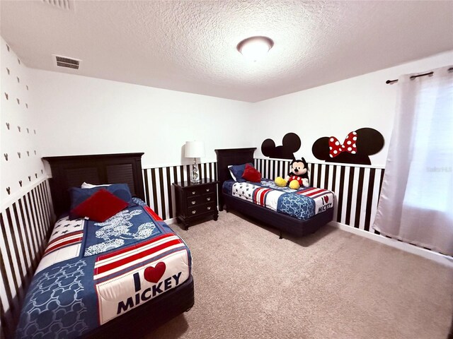 bedroom featuring a textured ceiling and carpet